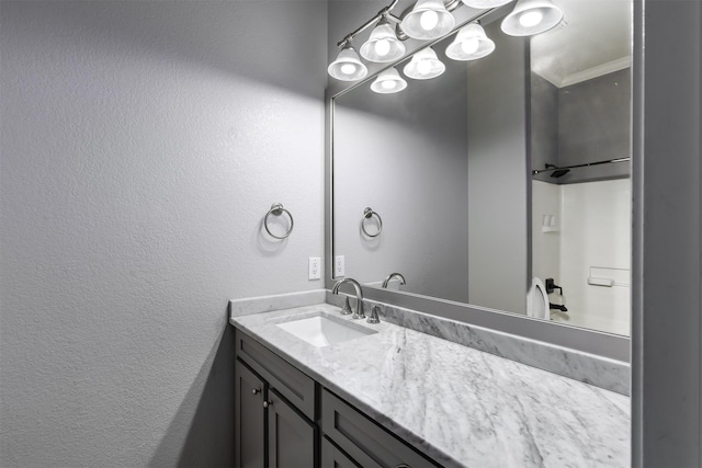 bathroom featuring crown molding and vanity