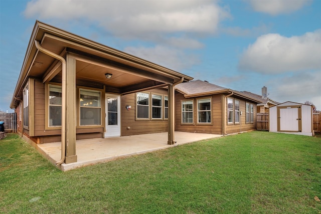 back of property with a yard, a storage unit, and a patio area