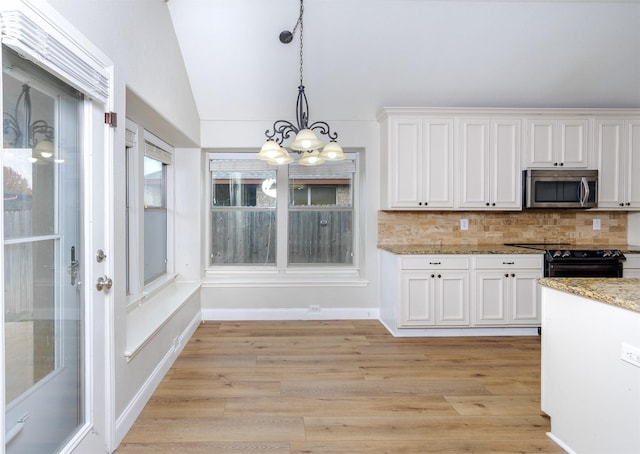 kitchen featuring black range oven, light wood-type flooring, white cabinetry, and vaulted ceiling