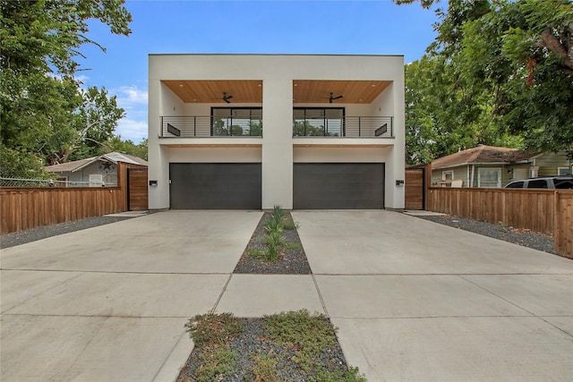 modern home featuring ceiling fan, a garage, and a balcony