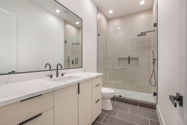 bathroom featuring walk in shower, tile patterned flooring, vanity, and toilet