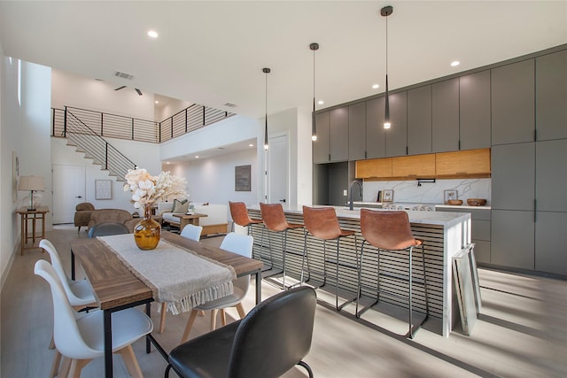 dining room with a towering ceiling