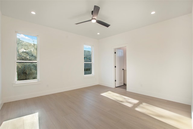 unfurnished room featuring ceiling fan and light hardwood / wood-style flooring