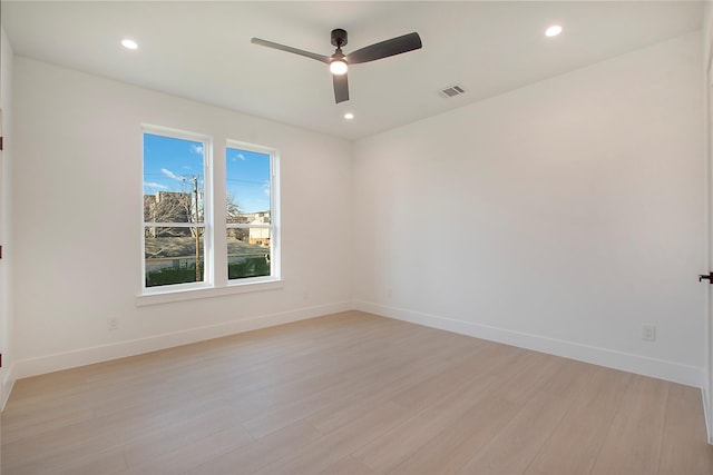 empty room with light hardwood / wood-style flooring and ceiling fan