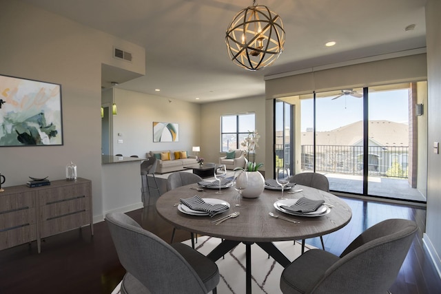 dining room with a mountain view, hardwood / wood-style floors, and an inviting chandelier