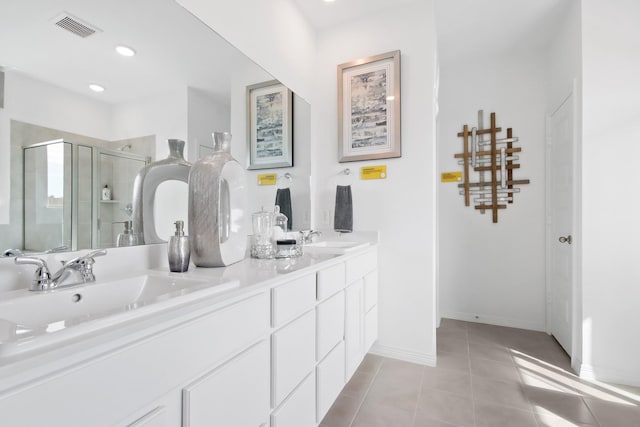 bathroom with tile patterned floors, vanity, and a shower with door