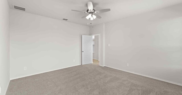 carpeted spare room with ceiling fan