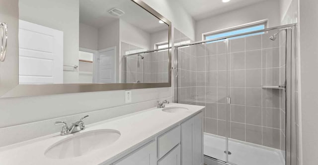 bathroom with vanity and a shower with shower door