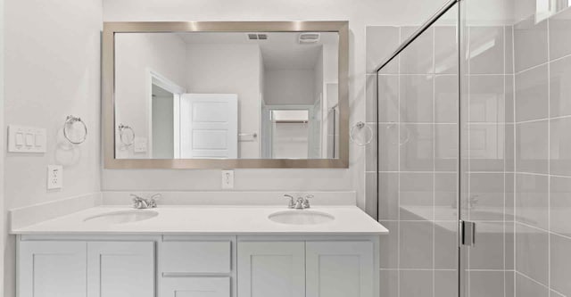 bathroom with vanity and a shower with shower door