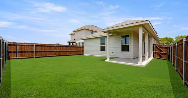 back of property with a yard and a patio area