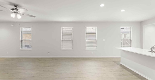 spare room featuring ceiling fan and light hardwood / wood-style flooring