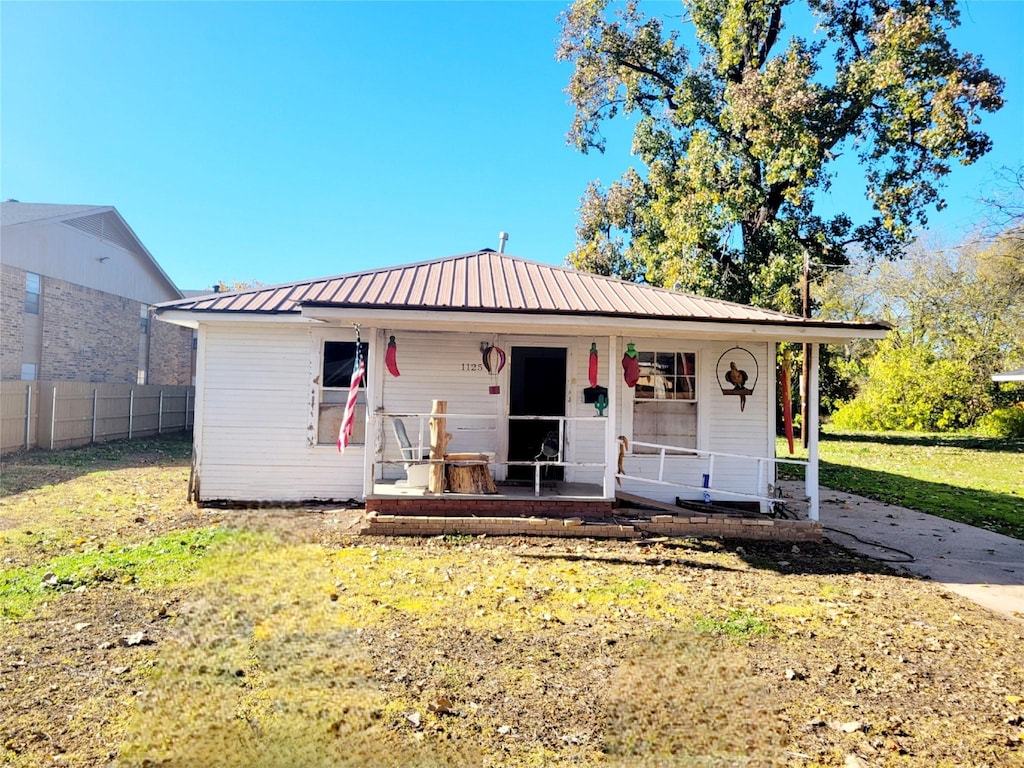 view of front of house with a front yard and a porch