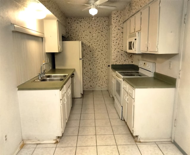 kitchen featuring white cabinetry, sink, light tile patterned floors, and white appliances