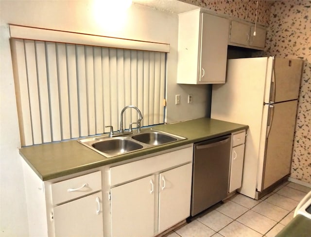 kitchen featuring sink, light tile patterned floors, dishwasher, and white refrigerator