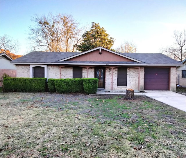 ranch-style home with a garage and a front yard