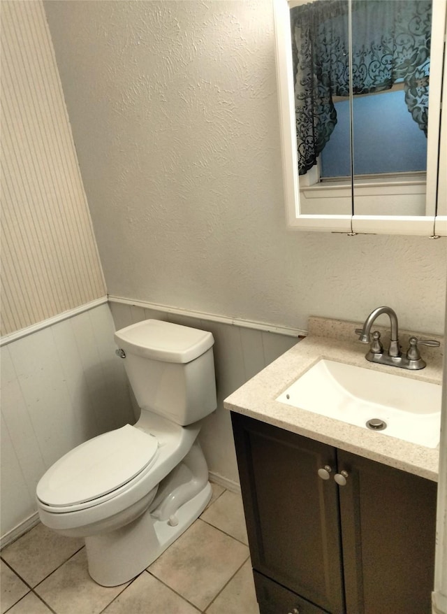 bathroom featuring toilet, vanity, and tile patterned floors