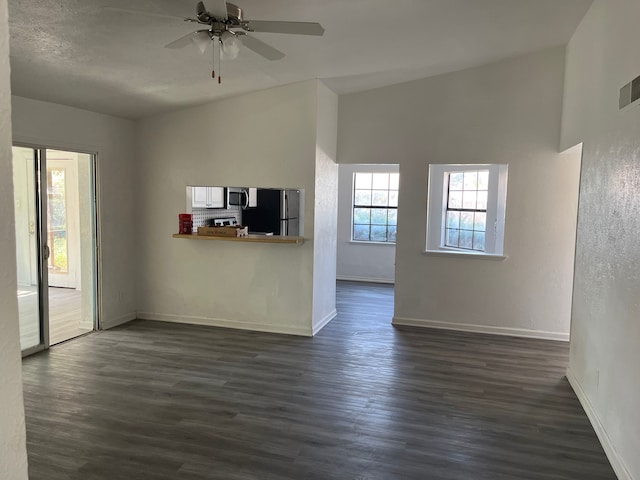 unfurnished living room with ceiling fan, dark hardwood / wood-style flooring, and high vaulted ceiling