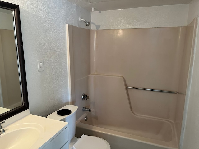 full bathroom featuring toilet, vanity, and tub / shower combination