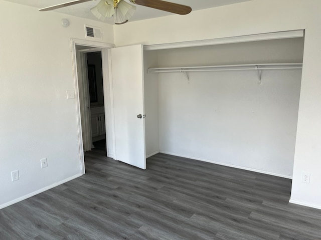 unfurnished bedroom featuring ceiling fan, a closet, and dark hardwood / wood-style floors