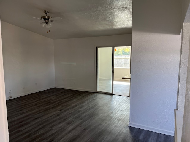 empty room with dark hardwood / wood-style floors and ceiling fan