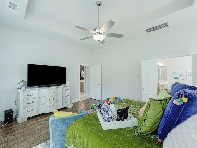 bedroom with ceiling fan, dark hardwood / wood-style floors, and connected bathroom