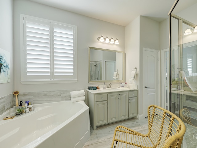 bathroom with vanity and separate shower and tub