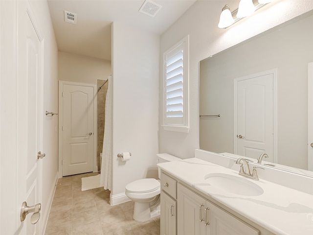 bathroom with tile patterned flooring, a shower, vanity, and toilet