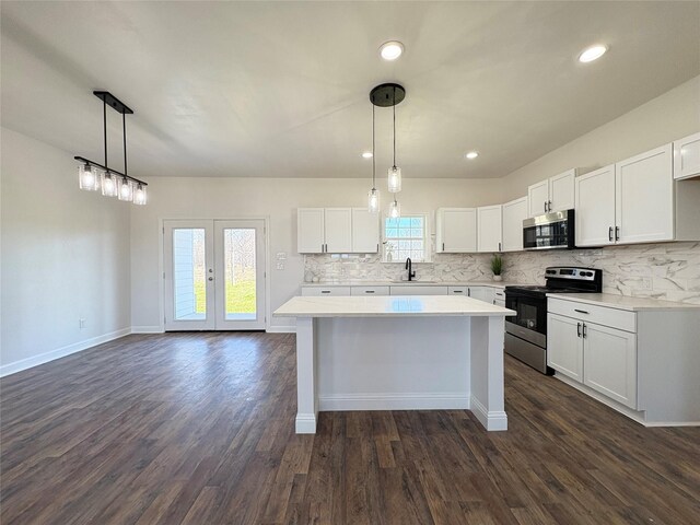 clothes washing area with electric dryer hookup, cabinets, dark wood-type flooring, and hookup for a washing machine