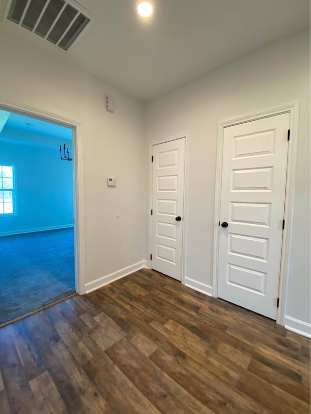 empty room with dark hardwood / wood-style flooring