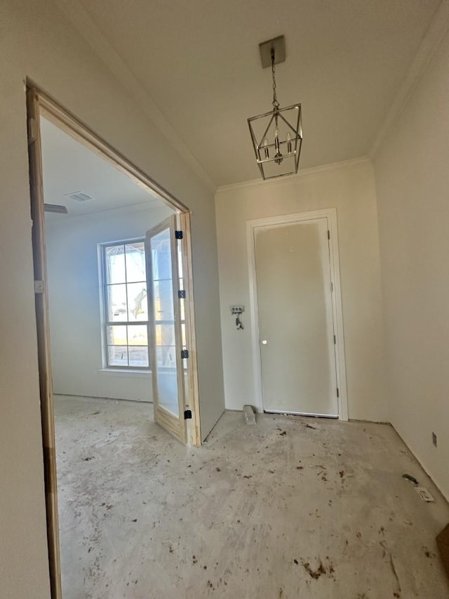 interior space featuring crown molding and a chandelier