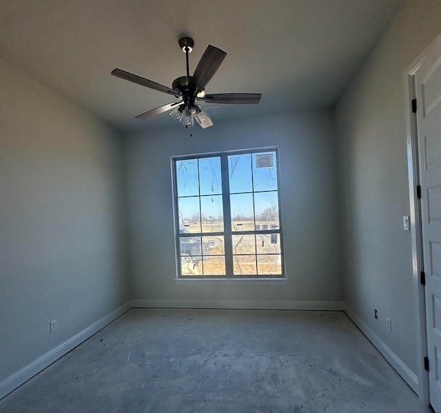 spare room with concrete floors and ceiling fan