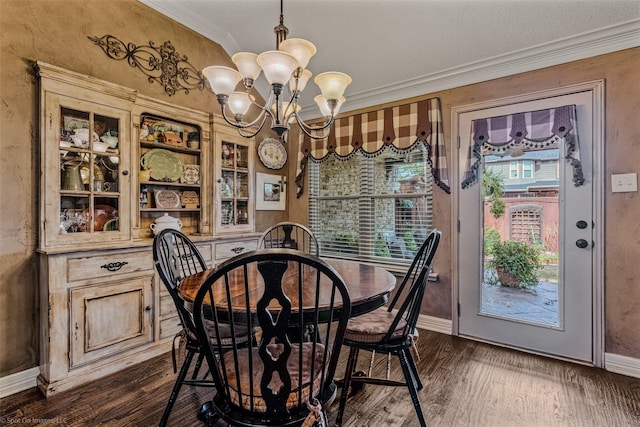 dining area with crown molding, a chandelier, and dark hardwood / wood-style floors