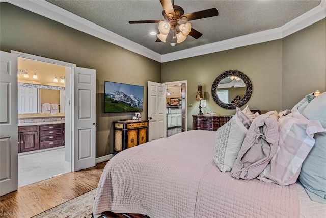 bedroom with light wood-type flooring, ensuite bathroom, ornamental molding, a textured ceiling, and ceiling fan