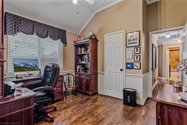 home office featuring dark wood-type flooring, vaulted ceiling, ceiling fan, ornamental molding, and a textured ceiling