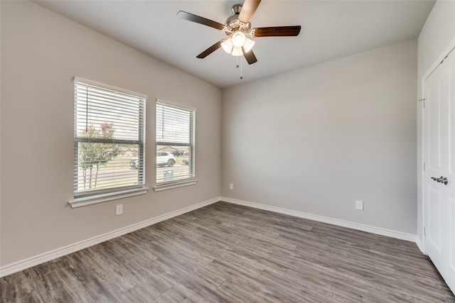 unfurnished room with ceiling fan and hardwood / wood-style flooring