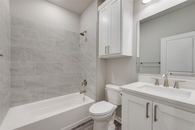 full bathroom with hardwood / wood-style floors, vanity, toilet, and tiled shower / bath