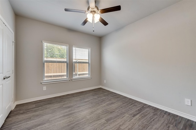 spare room featuring ceiling fan and dark wood-type flooring