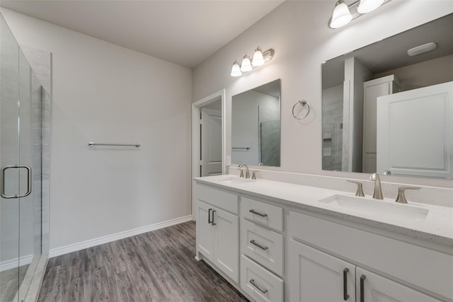 bathroom with vanity, wood-type flooring, and an enclosed shower