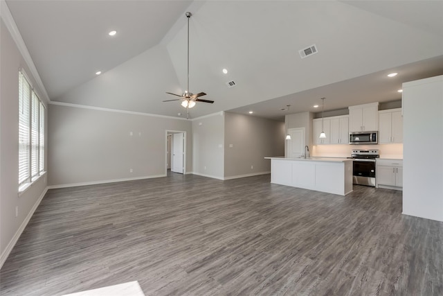 kitchen featuring a center island with sink, crown molding, appliances with stainless steel finishes, white cabinetry, and wood-type flooring