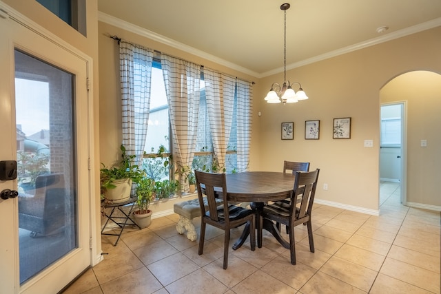 tiled dining area featuring a wealth of natural light, crown molding, and a chandelier