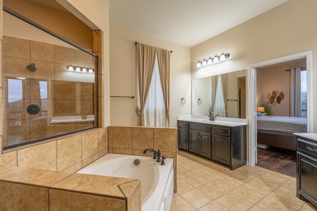 bathroom with tile patterned floors, vanity, and plus walk in shower