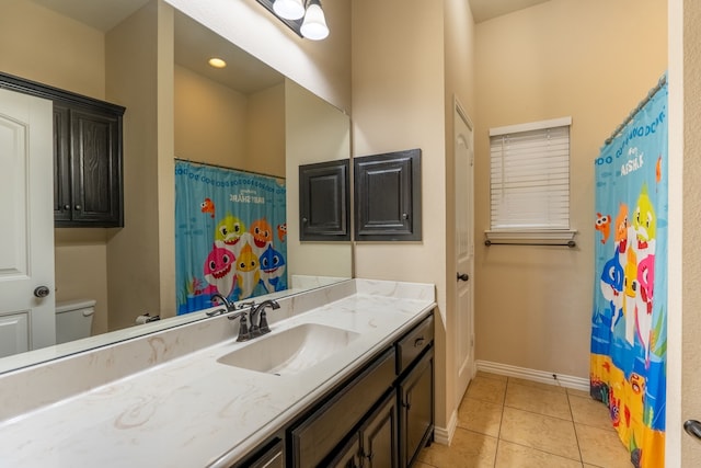 bathroom featuring tile patterned floors, vanity, and toilet