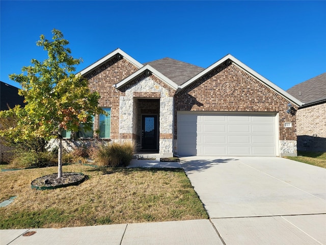 view of front of property with a front yard and a garage