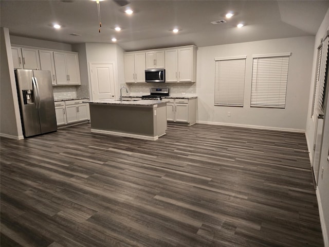 kitchen with sink, stainless steel appliances, white cabinets, and a center island with sink