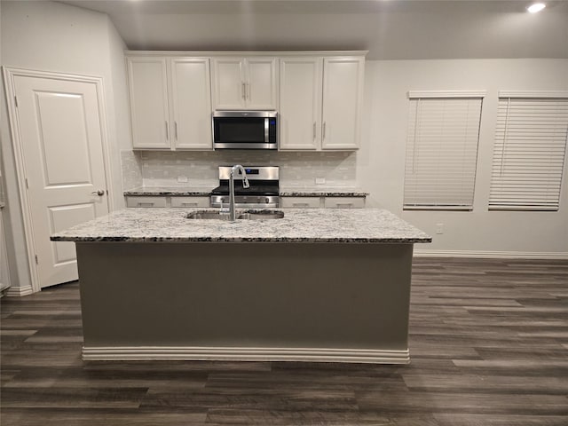 kitchen featuring sink, a center island with sink, white cabinets, and appliances with stainless steel finishes