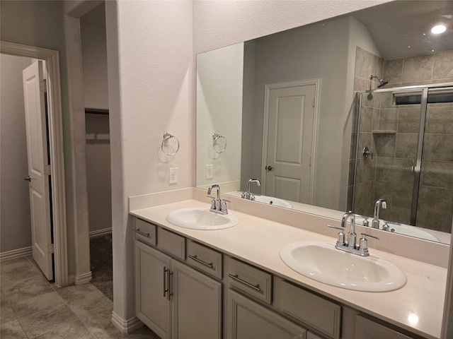 bathroom with vanity and a shower with door