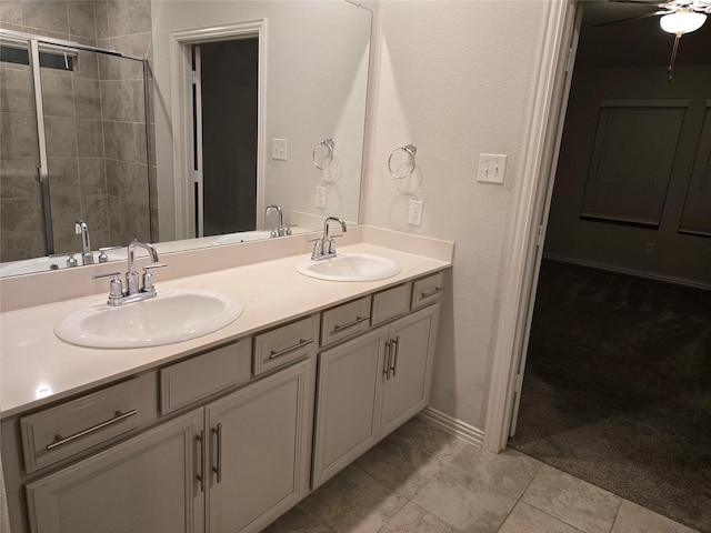 bathroom featuring ceiling fan, vanity, tile patterned flooring, and a shower with door