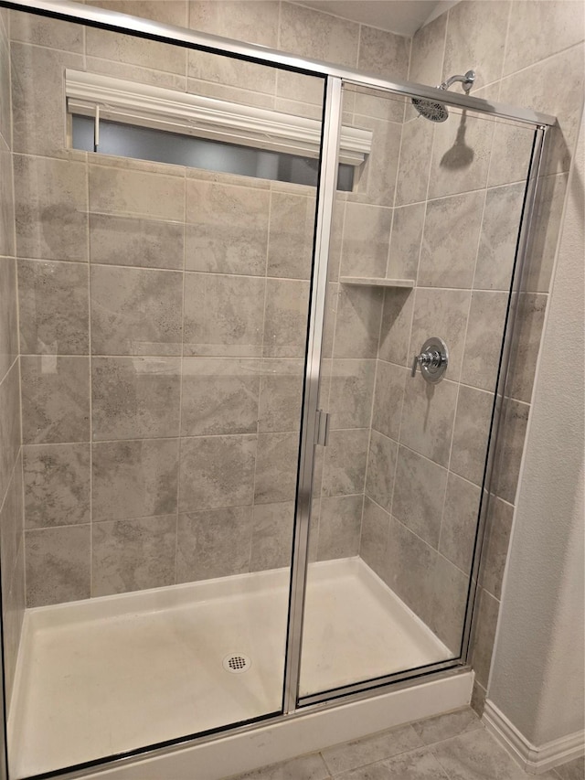 bathroom with a shower with door