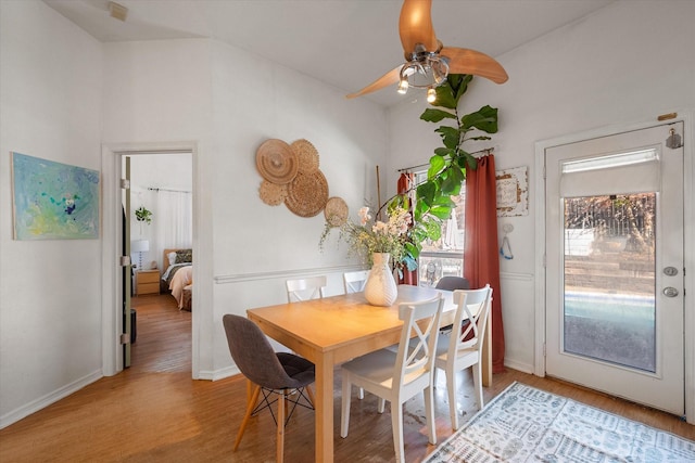 dining area with lofted ceiling, ceiling fan, and wood-type flooring