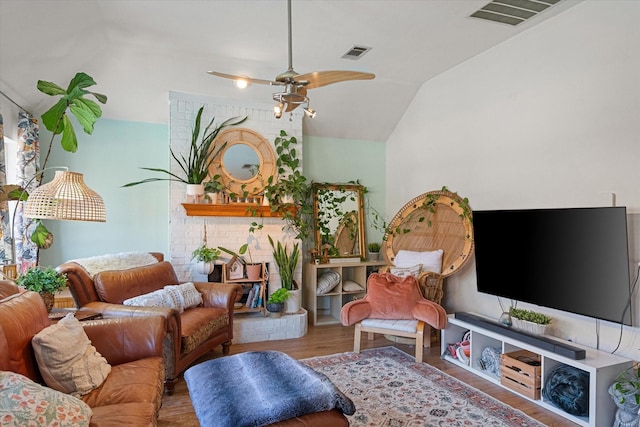 living room featuring hardwood / wood-style floors, vaulted ceiling, and ceiling fan